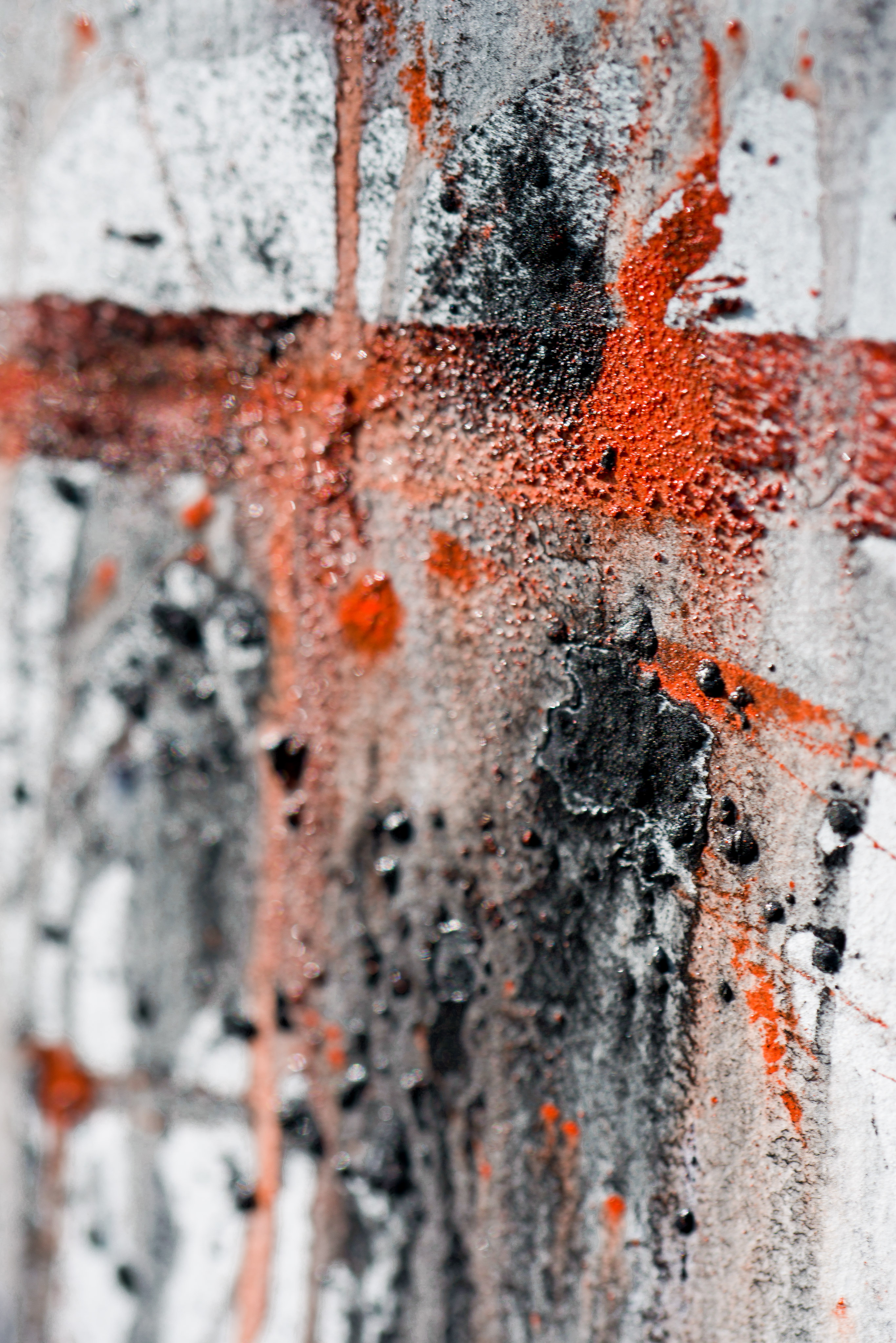 Macro detail of powdered pigments: cadmium orange and charcoal.